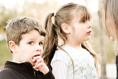 Close-up of mother talking to young daughter and son