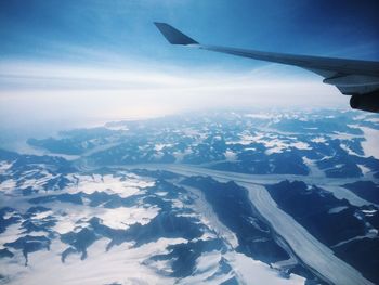 Cropped image of airplane flying over landscape