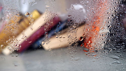 Books seen through wet glass window