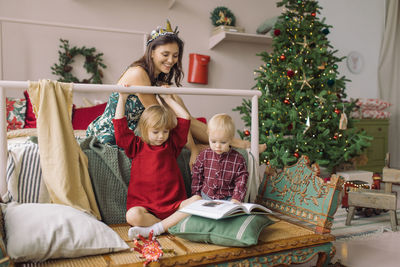 Cheerful family relaxing at home during christmas