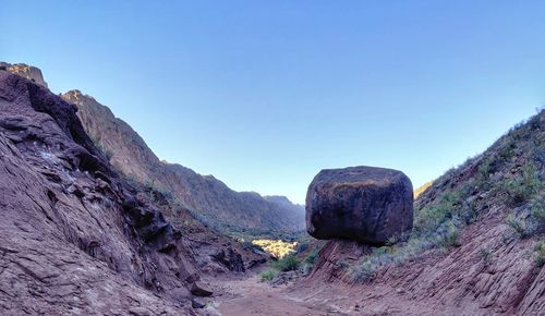 Rocks on mountain against clear sky