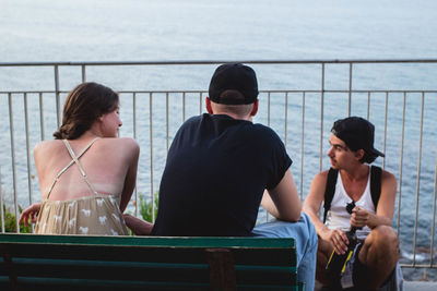 Friends sitting by river