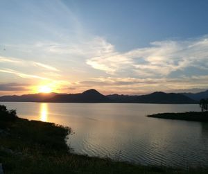 Scenic view of lake against sky during sunset