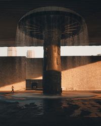 Digital composite image of fountain against building