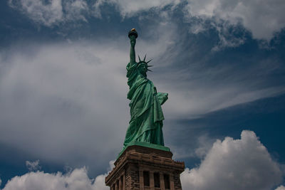 Low angle view of statue against cloudy sky