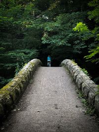 Rear view of woman riding bike