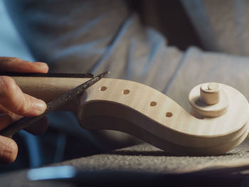 Luthier working a classic violin scroll