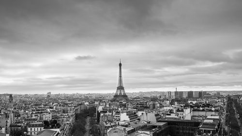 Eiffel tower in city against sky