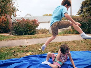 Full length of mother and daughter playing on farm