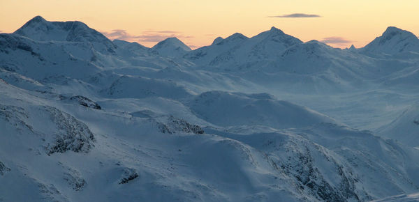 Scenic view of snow covered mountains against sky