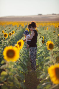 Full length of sunflower on field against sky