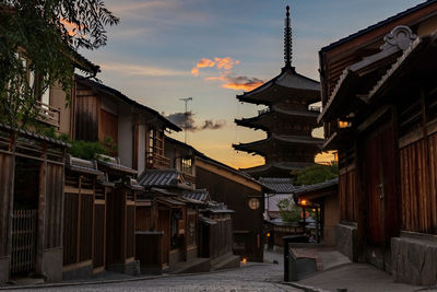 Buildings in city against sky during sunset