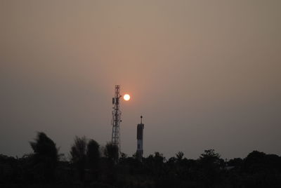Low angle view of silhouette trees against clear sky at sunset