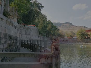 Scenic view of lake by building against sky