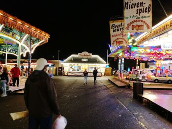 People at market in city at night