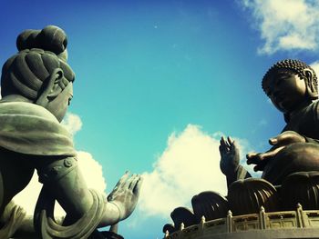 Low angle view of statue against cloudy sky