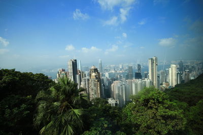 Panoramic view of trees and buildings against sky