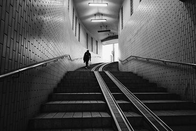 Rear view of woman walking on staircase