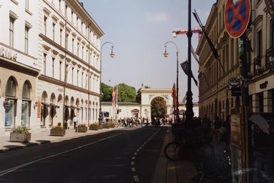 City street and buildings against sky