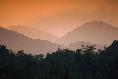 Scenic view of silhouette mountains against sky at sunset