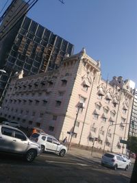 Low angle view of cars against clear sky