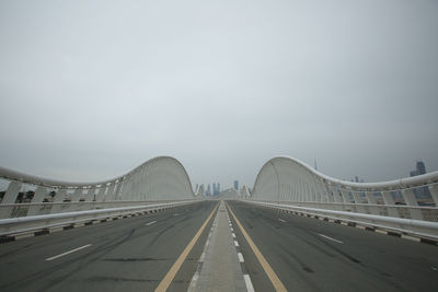 Bridge over highway against sky