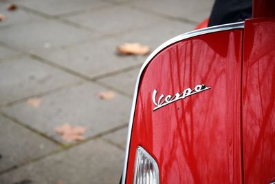 Close-up of text on red motor scooter