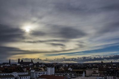 View of cityscape against cloudy sky