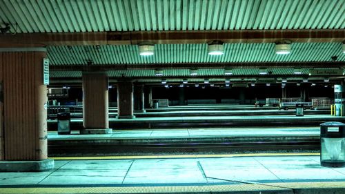 Illuminated railroad station platform at night