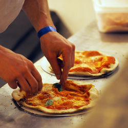 Midsection of man holding pizza