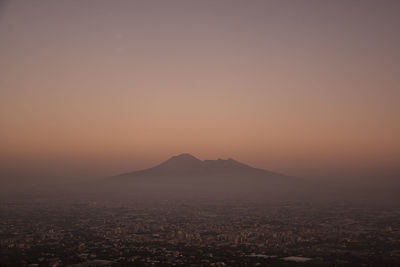 Scenic view of cityscape against clear sky during sunset