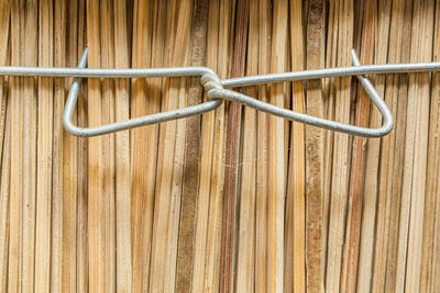 Close-up of metal against wood