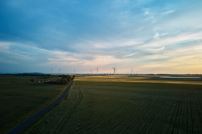 Windmill turbines at sunset, wind energy concept