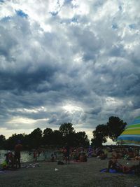 People in park against cloudy sky