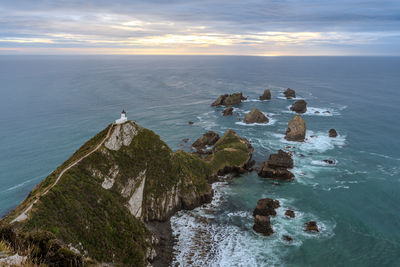 Nugget point lighthouse at sunrise, new zealand