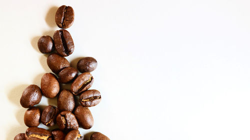 Close-up of coffee beans against white background