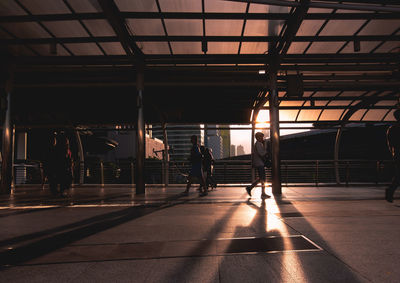 People walking on railroad station platform
