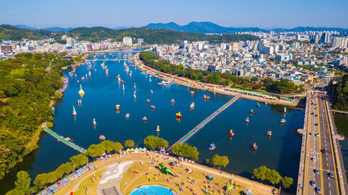 High angle view of swimming pool by buildings against sky