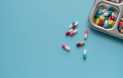 High angle view of medicines on blue background