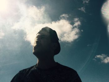 Low angle view of woman standing against sky