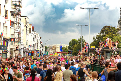 People on street in city against sky