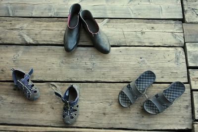 Close-up of shoes on wooden plank