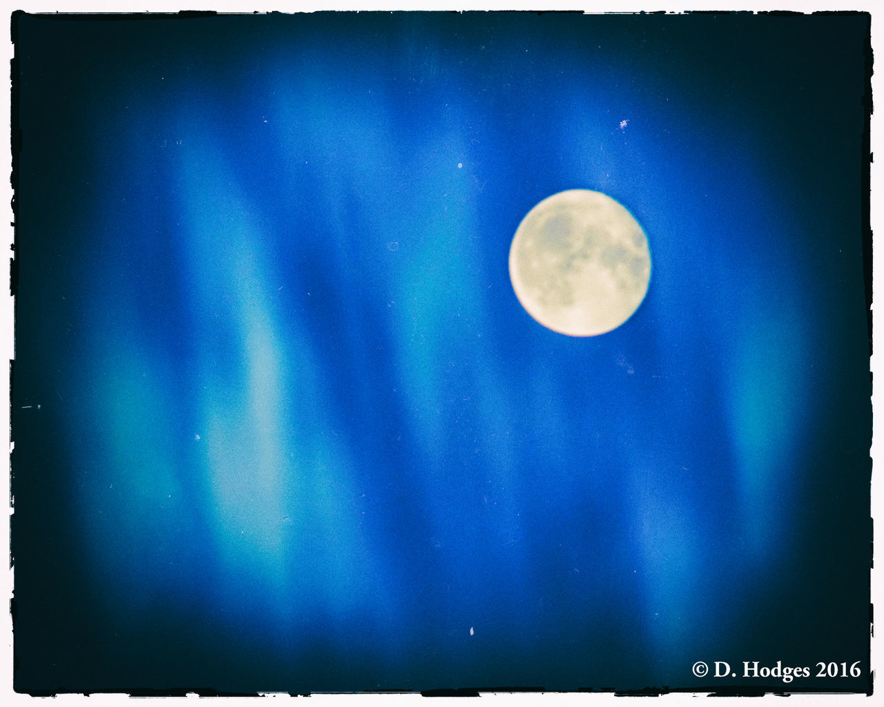 LOW ANGLE VIEW OF MOON IN BLUE SKY