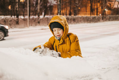 Portrait of young woman skiing on snow covered field