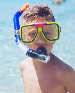 Portrait of shirtless boy swimming in pool