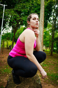 Beautiful young woman exercising in park