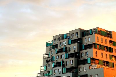 Low angle view of buildings against sky during sunset