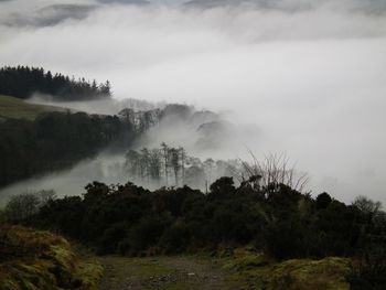 Scenic view of mountains against cloudy sky