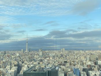 Aerial view of modern buildings in city against sky