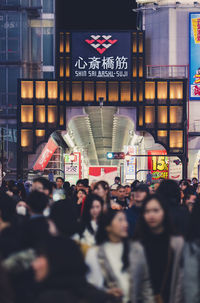 People walking in illuminated city